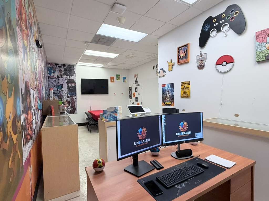 Front desk with Unsealed & Delivered Co. branded monitors