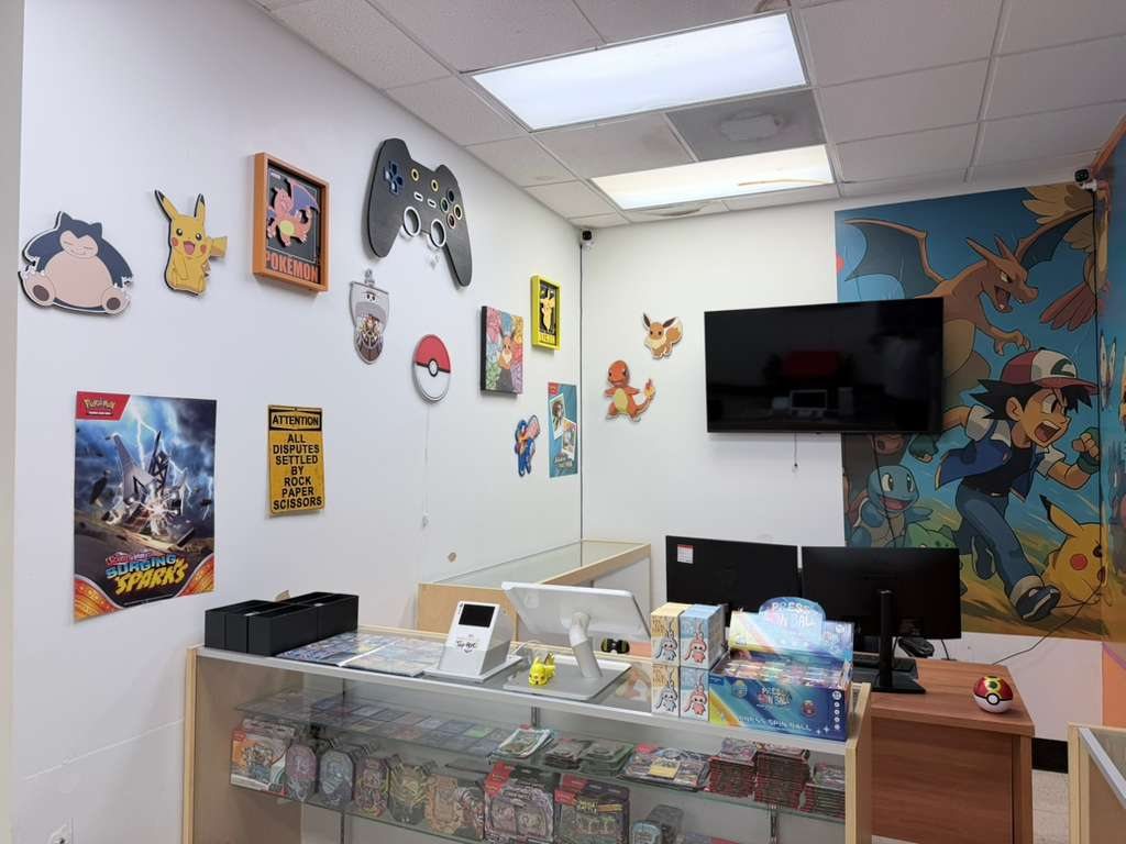Pokémon-themed display wall with an Ash and Charizard mural